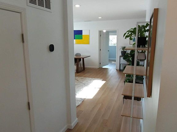 View of living room and one of the back rooms from the front of the house.
