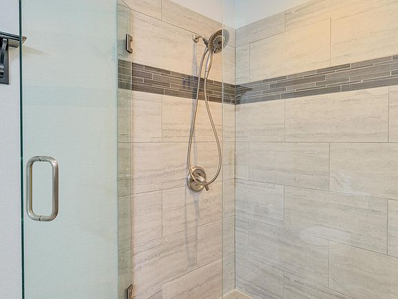 Modern master bathroom with double sink vanity and a beautiful walk in shower