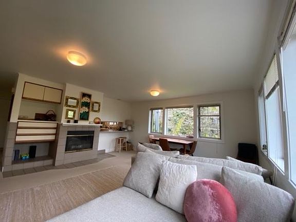 Another view of living/dining area. Shows built-ins and pass through bar to kitchen.