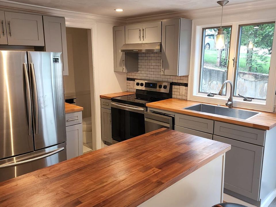 All new Samsung kitchen appliances, accompanied by soft closing cabinets, and butcher block counters