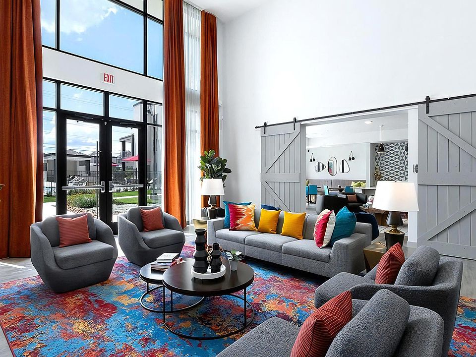 Colorful Resident Lounge Featuring High Ceilings and Floor-to-Ceiling Windows