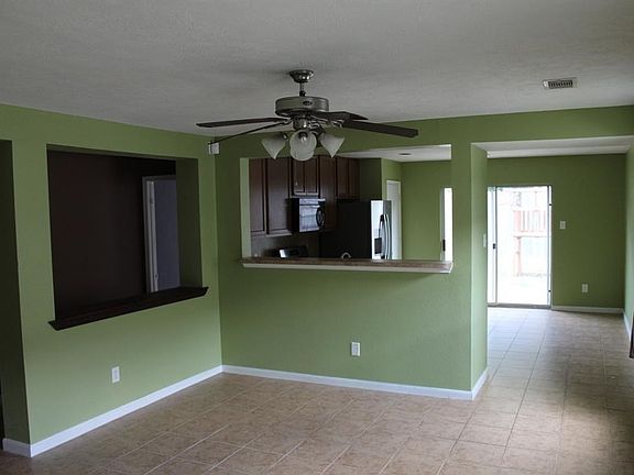 ENTRY WAY VIEW OF LIVING ROOM AND KITCHEN .