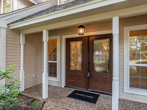 What an amazingly expansive presentation this front porch makes with its beautiful front doors with exquisitely designed glass inserts and elongated side windows!