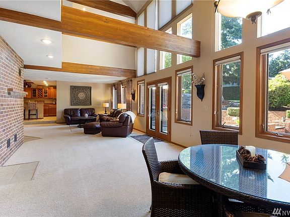 Open concept vaulted ceiling w/Russian FP, dining/family room & exterior access to huge entertainment patio & large manicured yard!