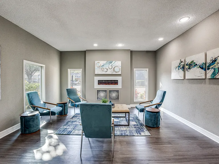 Community indoor lounge with chairs and fireplace