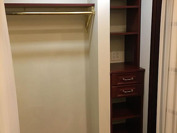 Hall Entry Closet with 4' Hanging Rod & Storage Cabinetry which includes both shelves and drawers