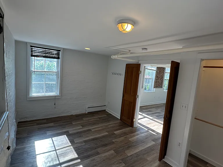 Bedroom facing full size window. Room can accommodate a queen bed.