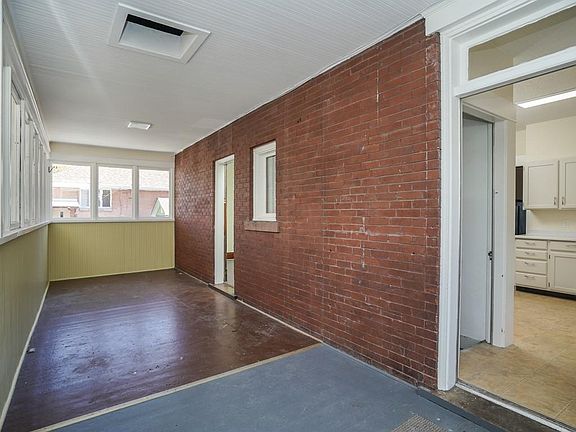 Spacious Sun Porch Entry at Back of House Accessing Kitchen.. Off Street Parking for 2 Cars.