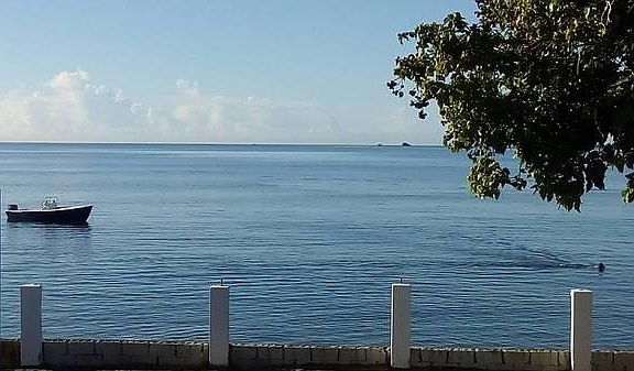 Artesanal fisherman casting nets and dive-fishing (see snorkeling fisherman on the right side of this photo) at sunrise just off the seaside yard, catching fresh conch, lobsters and fish.