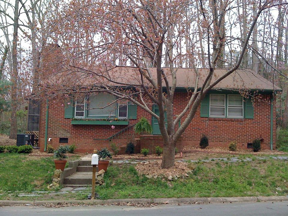 Front of Home with Blooming Cherry Blossom Tree
