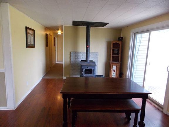 Enjoy your meals a little more in this dining room with newer flooring, fresh paint, new sliding glass door and a woodstove to add warmth to your gatherings.
