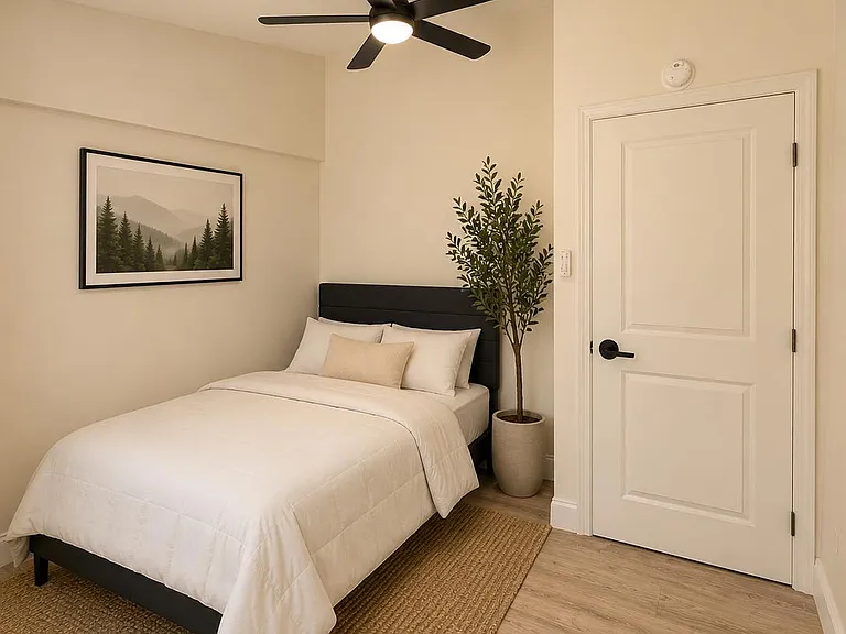 Well-appointed bedroom with a ceiling fan, comfortable bed setup, and durable flooring with space for essential furnishings.