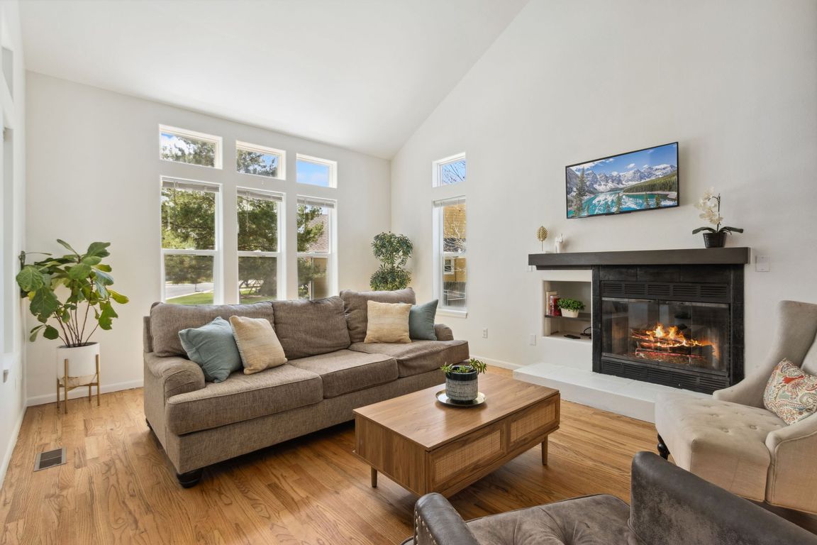 Vaulted ceilings, gas fireplace and natural light all make for a welcoming and comfy front living room.