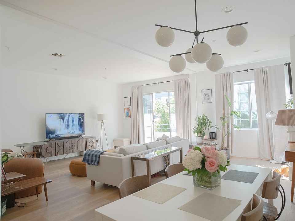 Family room with ample natural lighting. A sliding door opens out to the second floor balcony