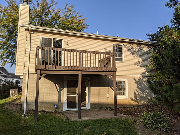 Rear deck and concrete patio off lower level.