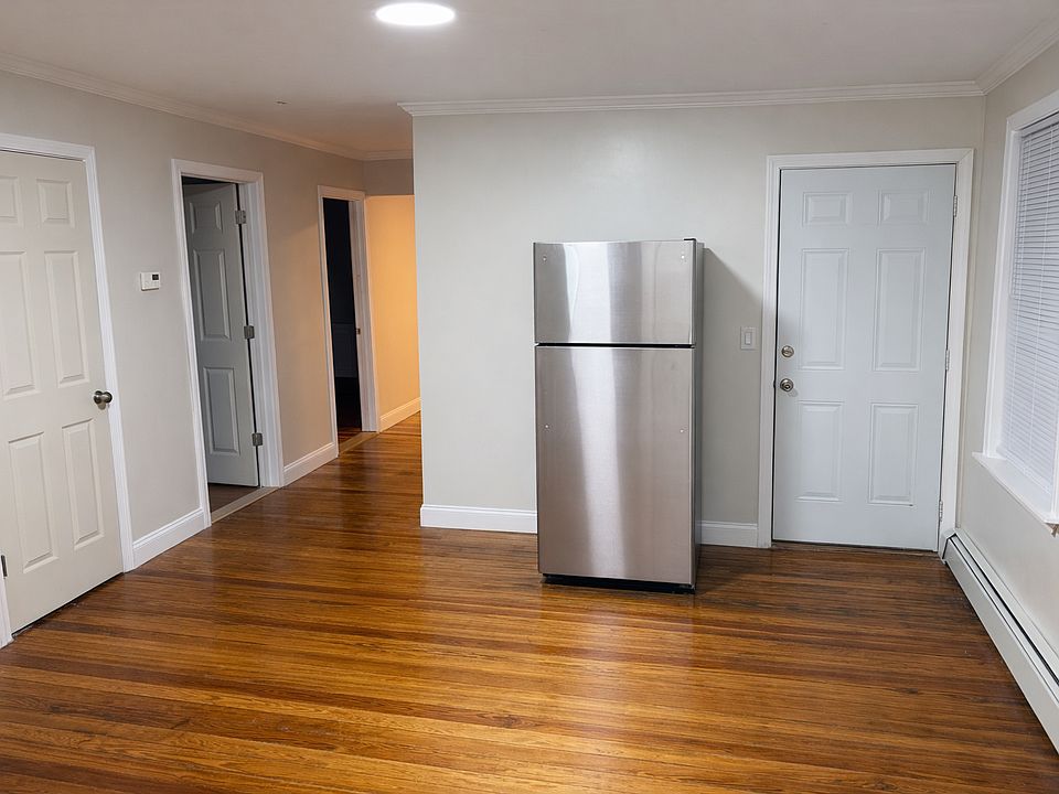 Dining area. Second entrance next to new stainless steel refrigerator. Doors leading to 2/3 bedrooms & closet.
