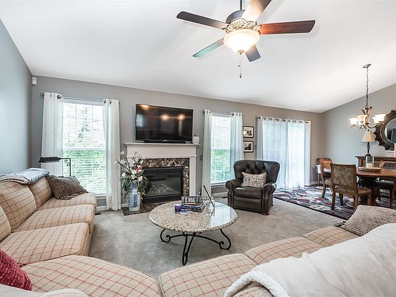 Family Room w/ Floor to Ceiling Windows, Gas Fireplace, and Vaulted Ceiling