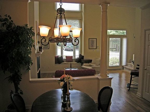  Dining area to fireplace with gas logs flanked by built-ins in greatroom 