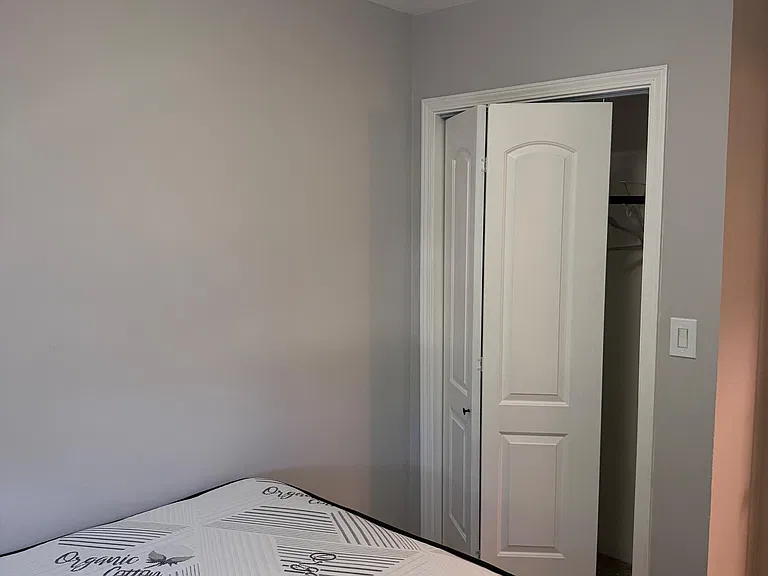 Private bedroom with overhead lighting and closet for convenient storage, offering a simple layout for easy furnishing.