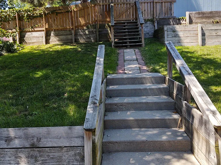 Backyard and Stairs to Garden Space, 2 Car Garage and Additional Parking.