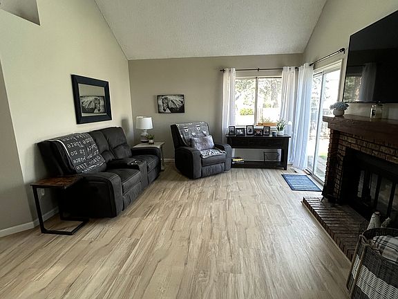 Living room with vaulted ceilings.