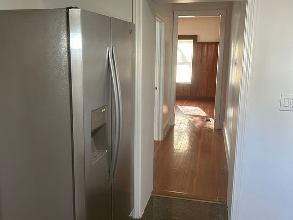 Fridge + hallway between kitchen to living room