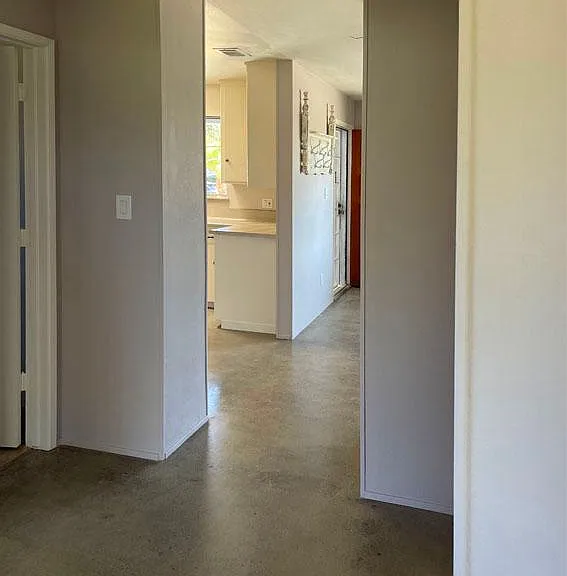Hallway. Space on right for narrow storage cabinets or chest of drawers for linens.