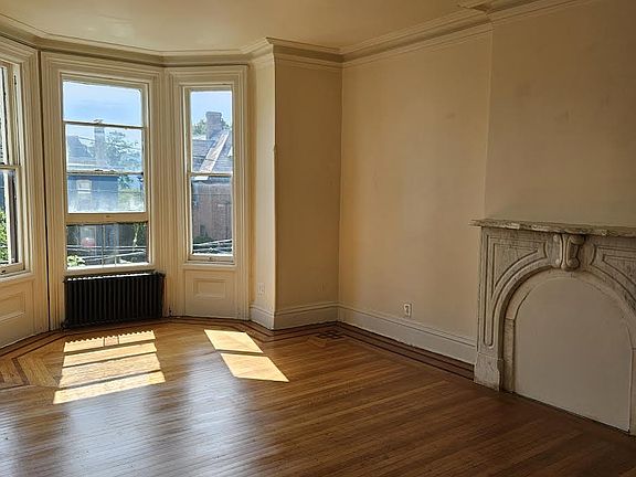 The living room faces west and has beautiful views of the historic East End landmarks of Newburgh and the Hudson.
