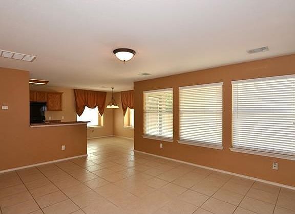 Standing in the foyer looking through the living area to the kitchen.