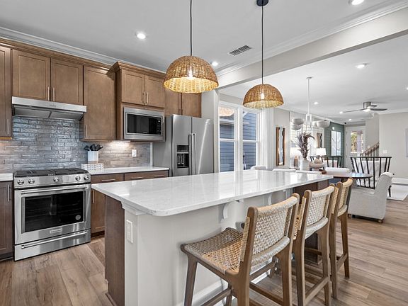 Large Kitchen Island with Seating. Model Home Representation.