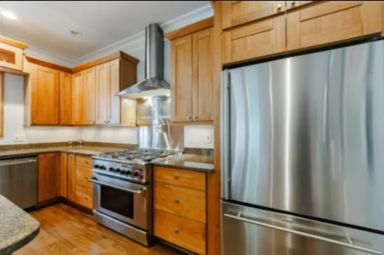 Kitchen with upgraded appliances and hooded gas range