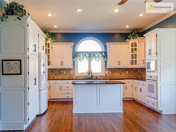 Light & Bright Kitchen boasts granite countertops, island, newer appliances, pantry, and tons of custom cabinets