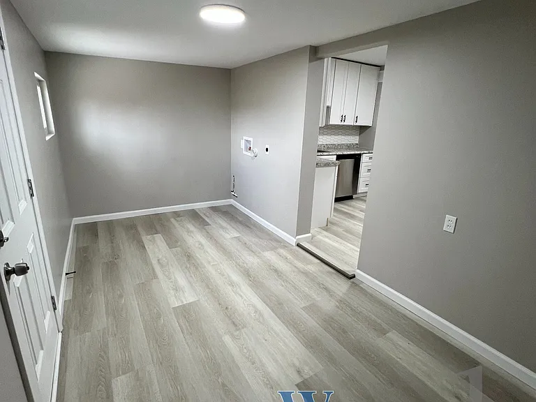 Additional view of laundry room facing away from backyard and towards kitchen.