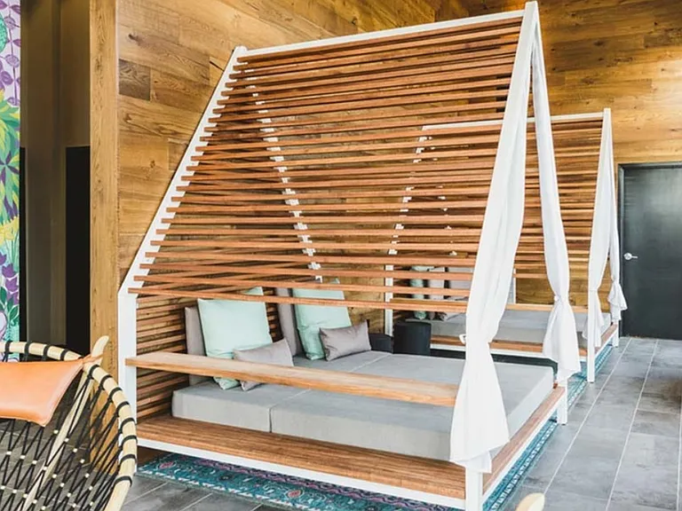 Relax in statement chaise lounges in open cabanas