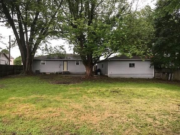 BACK VIEW OF HOME SHOWING DETACHED GARAGE AND HUGE BACK YARD.