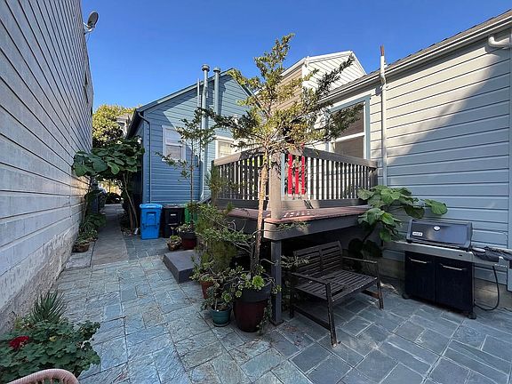 From your front door, this is what you see. The deck is the patio of a small studio. and the pathway leads outside. There's actually a bike-rack right behind it. Very nice and safe, as only 2 other tenants (long term) have access to the garden area