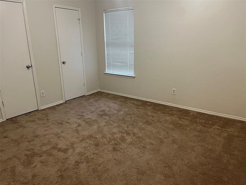 Unfurnished bedroom featuring carpet flooring and baseboards