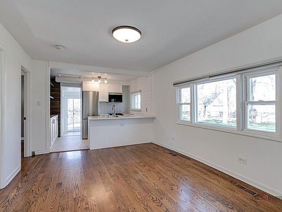 Open concept living room and kitchen - Looking from front of house to the back of the house.-