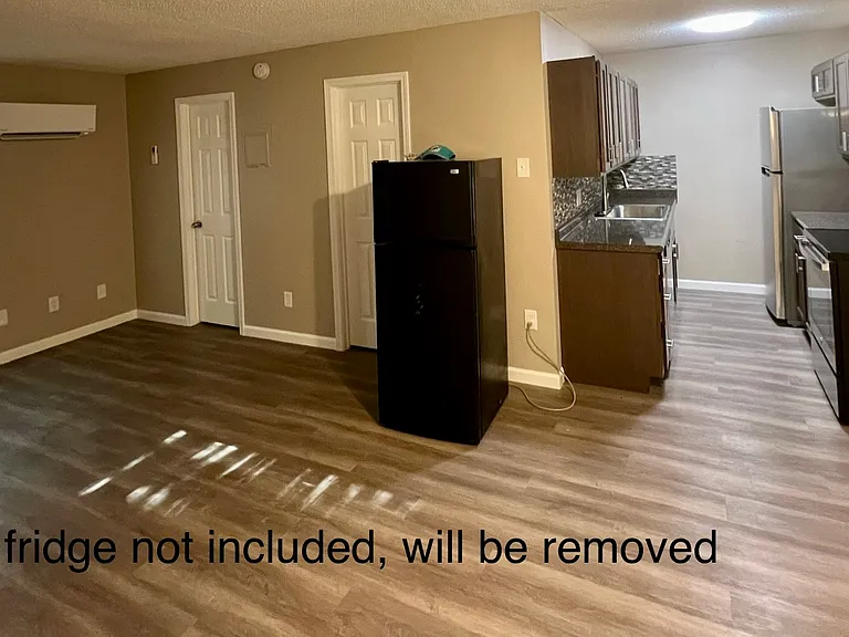 shows studio, kitchen and both doors to closet and bathroom and entry door and rear window and A/C