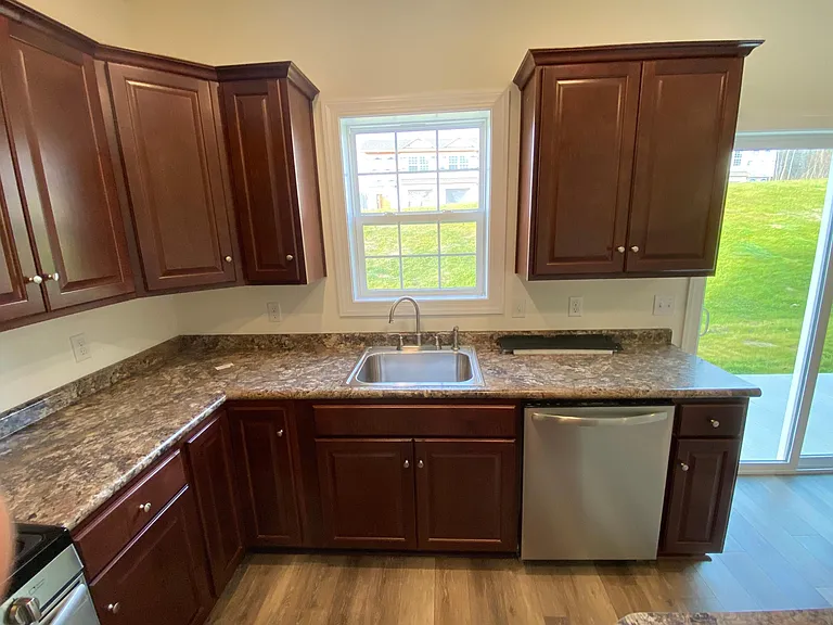 Kitchen Sink w dishwasher and cherry cabinets with soft close drawers
