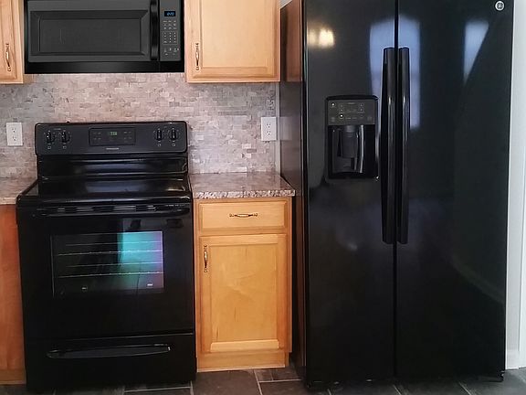 Kitchen with brand new appliances including dishwasher and m