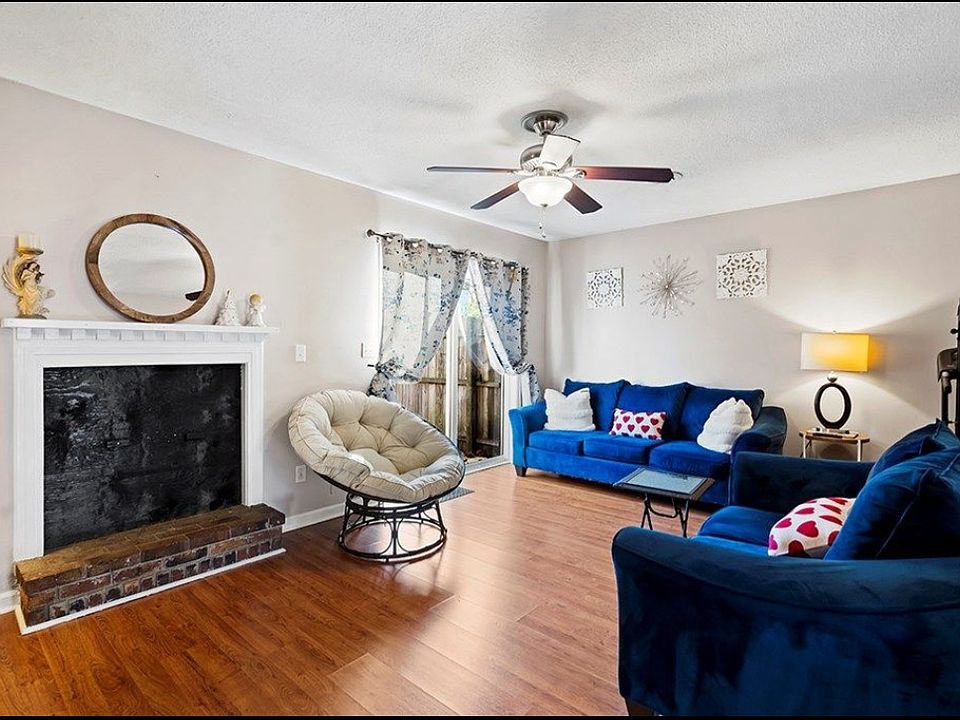 Living room with doors to fenced patio. Some decor has changed.