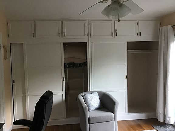 Large closet space with double doors and cabinets