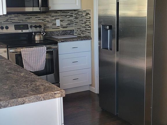 Kitchen with new microwave, new refrigerator and dish washing machine
