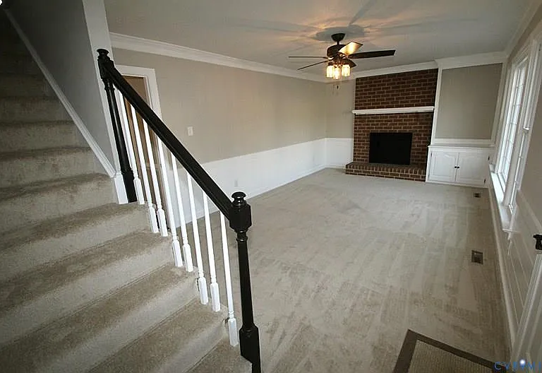 C-fan, and charming fireplace (for decorative purposes only) Rear facing staircase and door leading to the backyard is on the right.