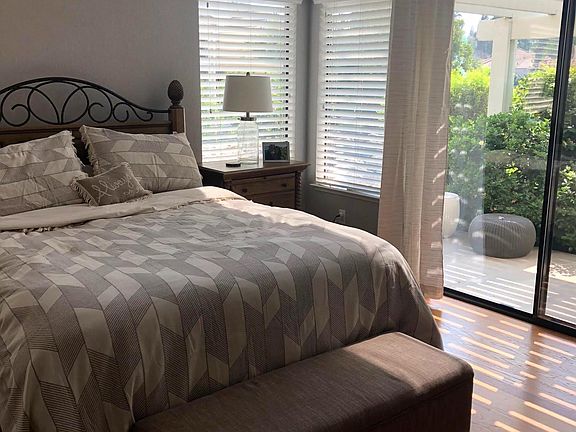 Master bedroom with access to the back patio and view of the lagoon