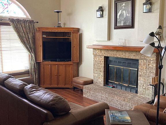 Family Room A (18x13)
Large South facing window & arch
Corner Hutch with Large SONY TV
Wood Burning Fireplace
Leather Couch & Recliner