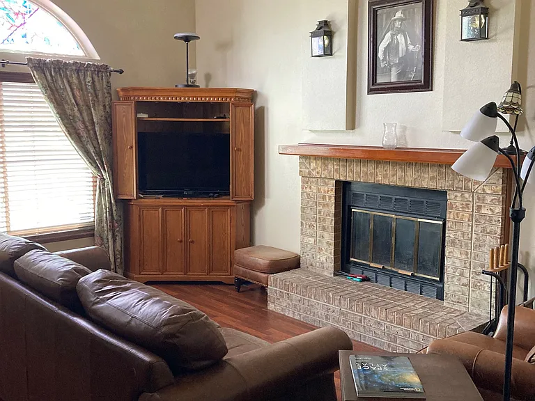 Family Room A (18x13)
Large South facing window & arch
Corner Hutch with Large SONY TV
Wood Burning Fireplace
Leather Couch & Recliner