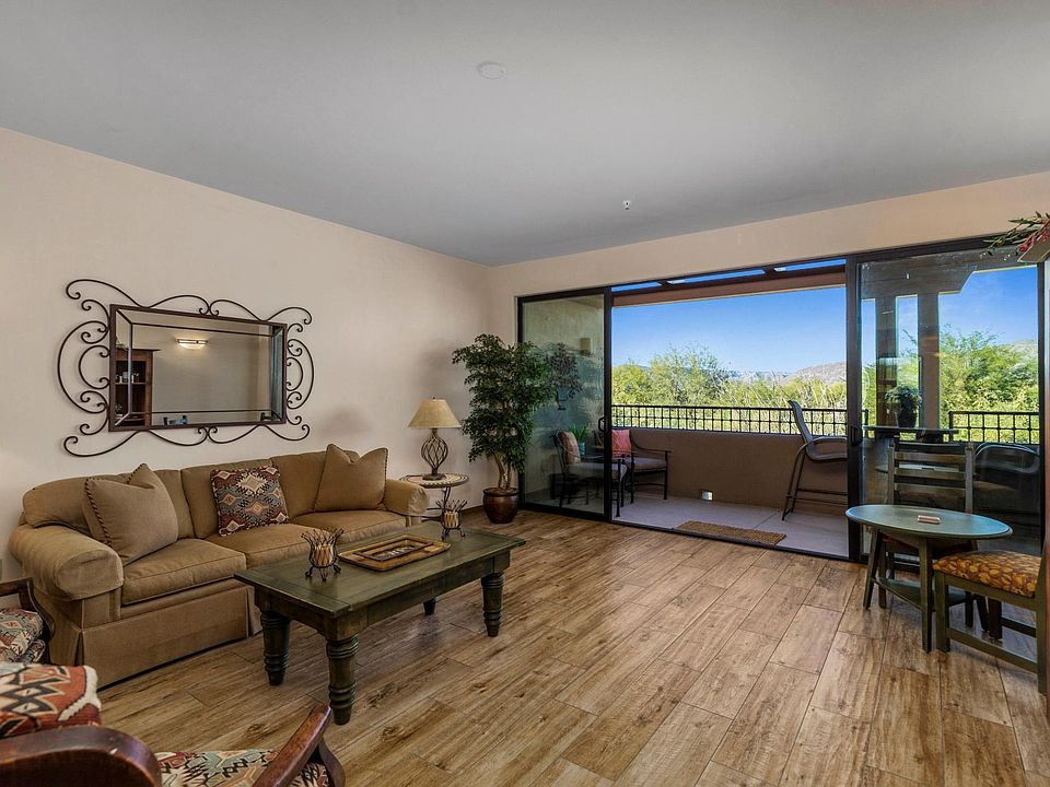 Floor to ceiling glass doors open to 
outside balcony/patio overlooking a beautiful view of the desert and golf course.