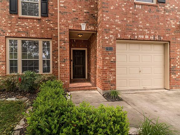 NOTICE THE TRADITIONAL STYLE OF SHADES OF RED BRICK, BLACK SHUTTERS, AND A PORCH OF COURSE!